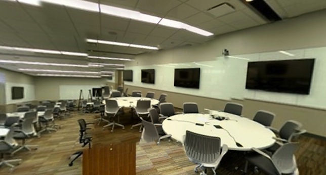 The new learning spaces include round, wired tables that let participants project their projects to computers in their groups or to classroom displays.
