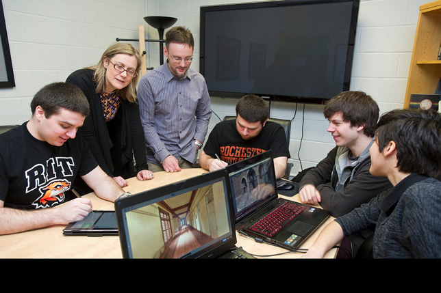Rochester's Chair of Humanities, Lisa Hermsen, with Assistant Professor Shaun Foster and students view a virtual 3D model of the Buffalo State Asylum for the Insane. Photographer: A. Sue Weisler.