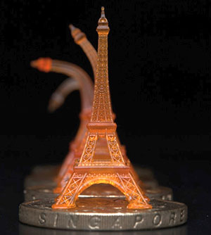 An Eiffel tower is bent, then straightens on its own to its original form after being heated through a Singapore dollar coin. Photo courtesy of Qi (Kevin) Ge.