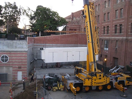  A crane lowers UCLAs pod into its new home, a former loading zone.