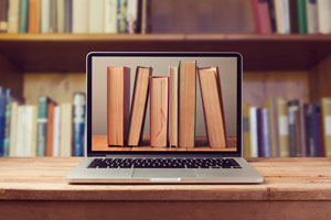 laptop computer with books on screen