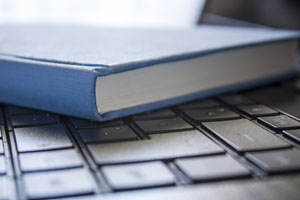 book sitting on laptop keyboard