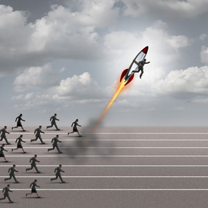 group of business people running on a track with a businessman on a rocket ship breaking away