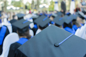 closeup of graduation cap in a crowd of graduates