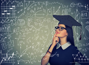 woman in graduation cap looking up at formulas