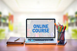 laptop on desk with "online course" on screen