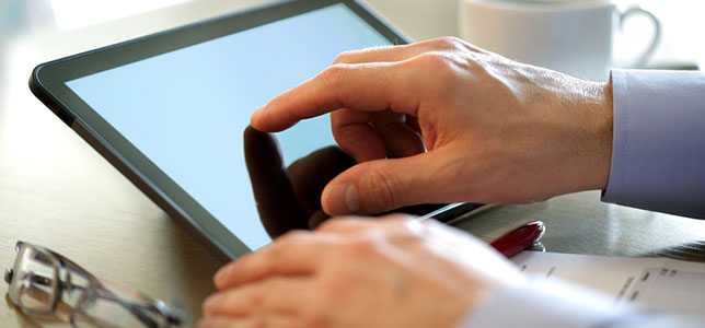 close up of hands with tablet