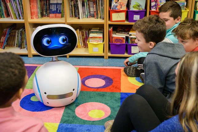 Fifth graders at the College School, located on the University of Delaware's Newark campus, watch Zenbo the social robot describe good habits for using safe computing.