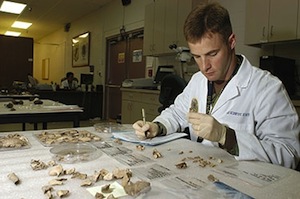 A United States Navy forensic odontologist studies dental remains of a possible missing service member.An Iowa State-hosted forensic science center of excellence is expected to improve the standards for the statistical analysis of forensic evidence. Photo credit: Cpl. James P. Johnson, U.S. Army.