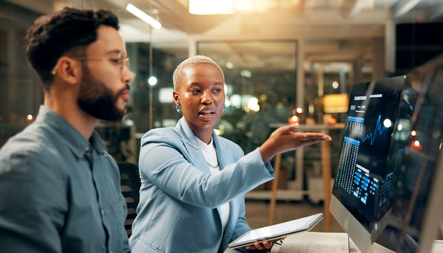 two coworkers collaborating at a computer