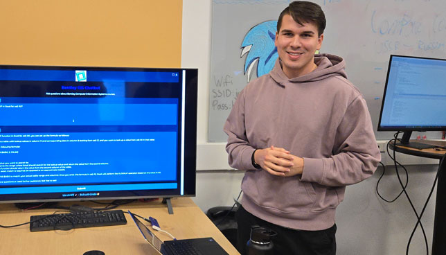 Anton Spiridonov, a senior at Bentley University majoring in Computer Information Systems, demonstrates his chatbot at a recent technology projects open house.