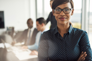 businesswoman in meeting with other workers in the background