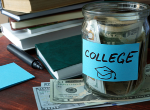 jar filled with money, labeled "college," on a table with money and books