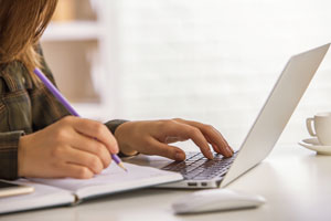 closeup of student working on laptop