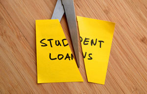 student loans being cut with scissors