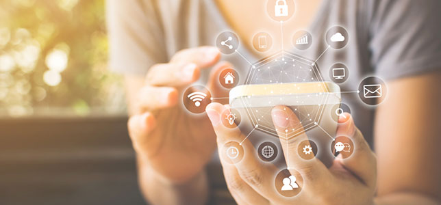 woman using smartphone with internet of things icons