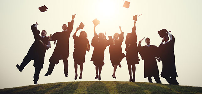 graduates throwing up their caps