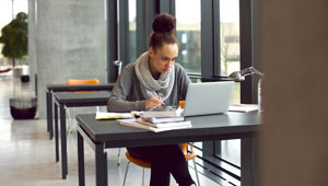 college student studying with laptop