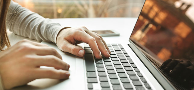 closeup of hands on laptop