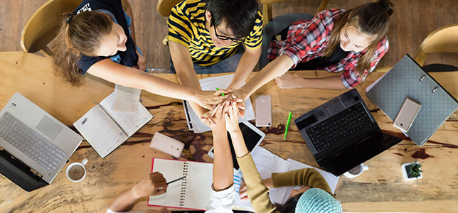 group of students high fiving