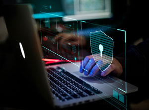 close up of hands working on laptop with security symbols