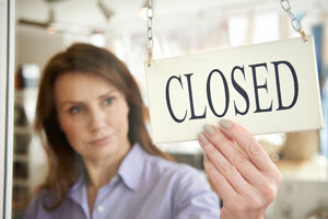 woman flipping over closed sign