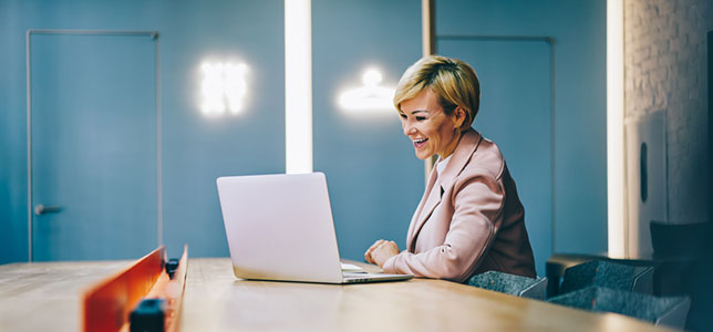 smiling woman working on laptop