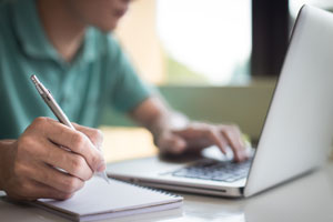 closeup of student working on laptop