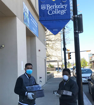 Berkeley College public safety staff prepare to distribute laptop computers to students at the start of the spring semester