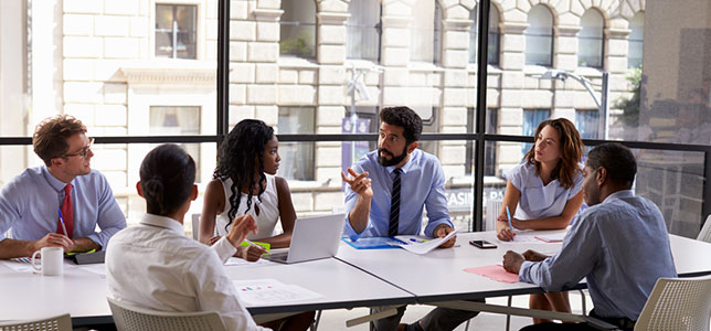 people sitting around a table in a business meeting