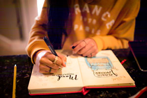 woman writing in journal