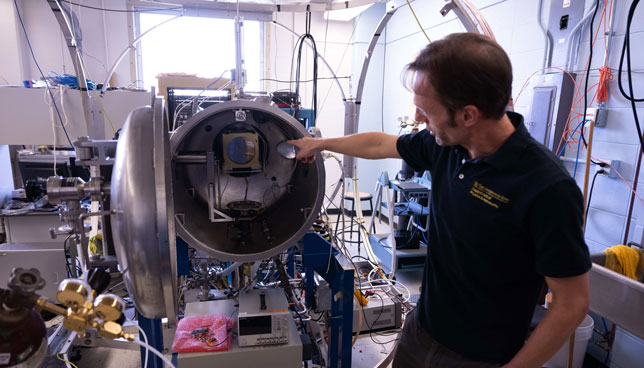 Jasper Halekas, instrument lead for the Analyzer for Cusp Electrons (ACE), checks final calibration. ACE was designed and built at the University of Iowa for the TRACERS mission.