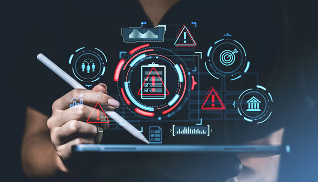 Hand holding a stylus over a tablet with futuristic risk management icons