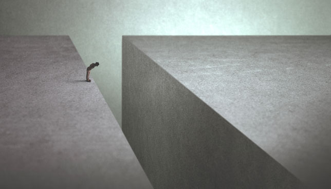 man on the edge afraid of jumping onto the other side 