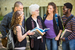 group of college students talking with administrator