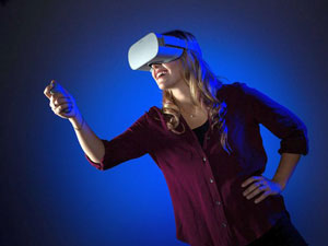 University of Nevada Reno Multimedia Production Specialist Michelle Rebaleati tries out a virtual reality headset.