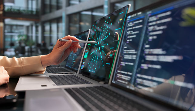 Young Woman Programmer Uses Laptop To Analyze Neural Network Models 